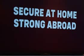 The words 'secure at home, strong abroad' in the foreground following a speech by Sir Keir Starmer last year