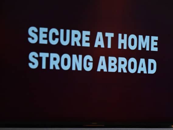 The words 'secure at home, strong abroad' in the foreground following a speech by Sir Keir Starmer last year