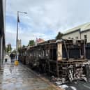 A burned-out Glider bus on Newtownards Road in east Belfast after anti-immigration violence
