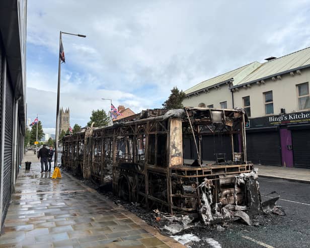A burned-out Glider bus on Newtownards Road in east Belfast after anti-immigration violence