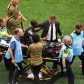 Canada head coach Jesse Marsch consoles Ismael Kone as he is carried off the field on a stretcher in the 6-0 World Cup win over Qatar