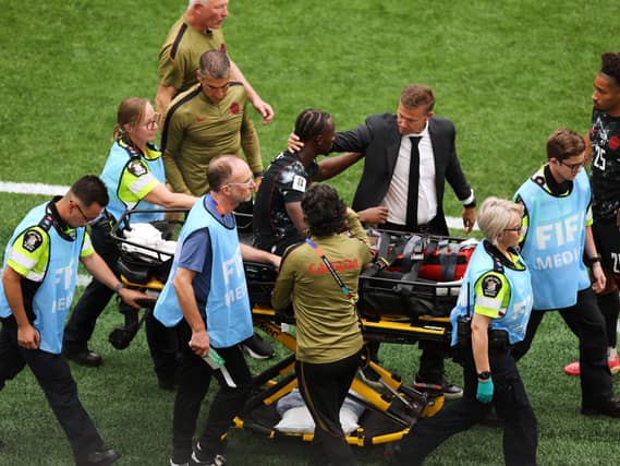 Canada head coach Jesse Marsch consoles Ismael Kone as he is carried off the field on a stretcher in the 6-0 World Cup win over Qatar