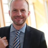 Stephen Gethins smiling in a Holyrood corridor