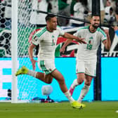 Algeria’s Nadhir Benbouali, left, celebrates after scoring his side’s opening goal