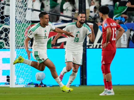 Algeria’s Nadhir Benbouali, left, celebrates after scoring his side’s opening goal