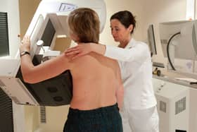 A woman undergoes breast screening