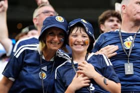 A woman and young boy in Scotland tops smiling