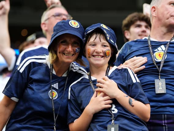 A woman and young boy in Scotland tops smiling