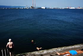 People enjoy the sunshine on the Bull Wall in Dublin