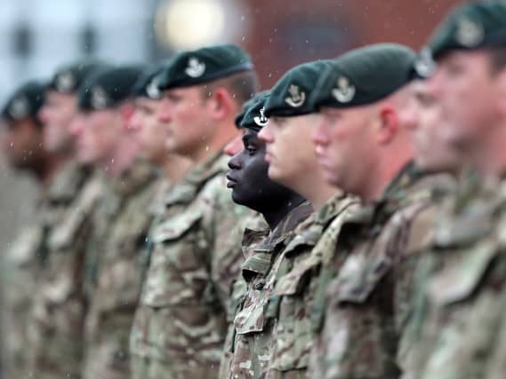 A view of Army personnel in uniform, standing in a line