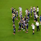 Steve Clarke and players on the pitch after Scotland's match against Brazil