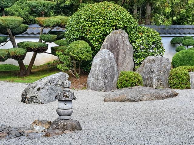 The garden uses rocks and tilled gravel to portray water and islands