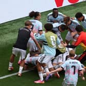 Youri Tielemans celebrates with teammates