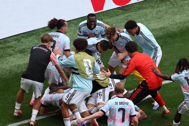 Youri Tielemans is mobbed by his Belgium team-mates