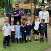 Darts star Luke Woodhouse, headteacher Lee Davis-Powell and some of early years children at Claregate Primary School