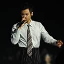 Harry Styles singing a song on stage
