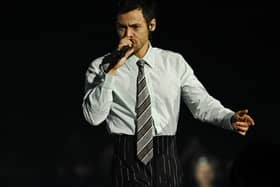 Harry Styles singing a song on stage