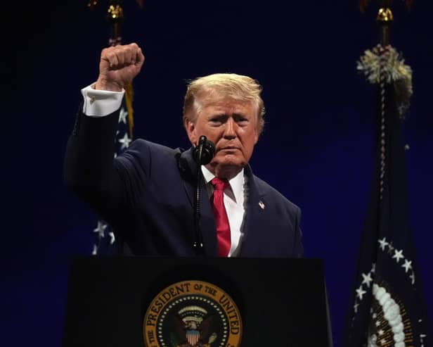 President Donald Trump gestures at the conclusion of his speech