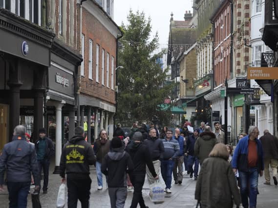 Shoppers make their way along a high street