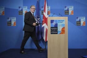 Keir Starmer walks towards a lectern to hold a press conference at the 2025 Nato summit in The Hague