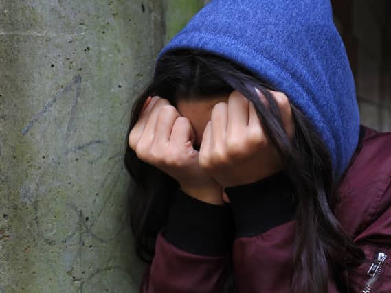 A teenage girl looking stressed