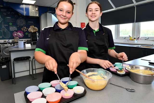 Poppy Wareham and Ivy Armitage work in the kitchen teaching area