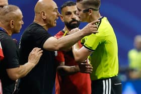 Egypt head coach Hossam Hassan argues with referee Francois Letexier during the World Cup round of 16 match against Argentina in Atlanta