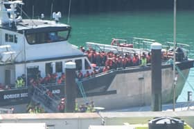 People in life jackets disembarking a boat in port