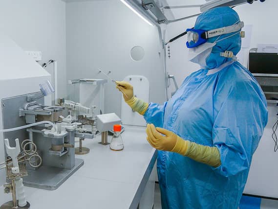 Staff work inside the AstraZeneca laboratory in Macclesfield