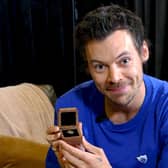 Harry Styles holding his Blue Peter Gold Badge