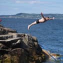People jump into the water
