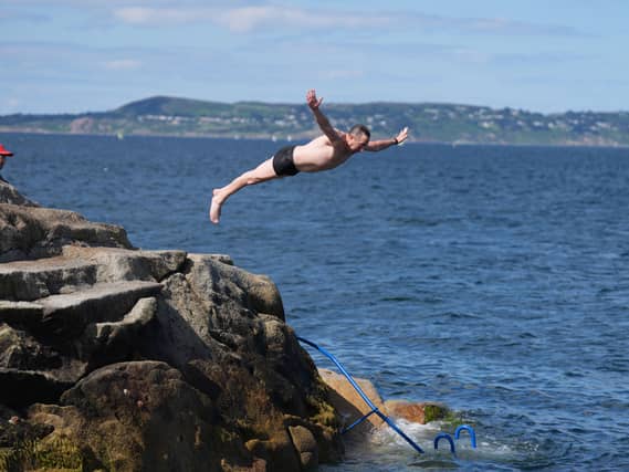 People jump into the water