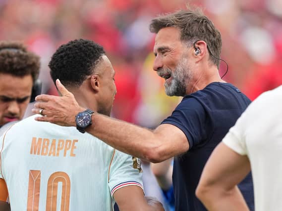 Former Liverpool manager Jurgen Klopp hugs France’s Kylian Mbappe