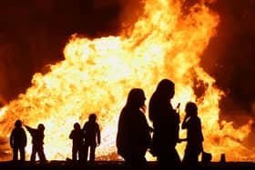 Battle of the Boyne bonfires with people sillouhetted in front