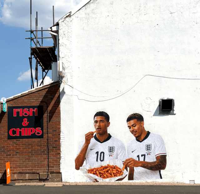 Mural of Jude Bellingham and Morgan Rogers eating orange chips appears in Quinton