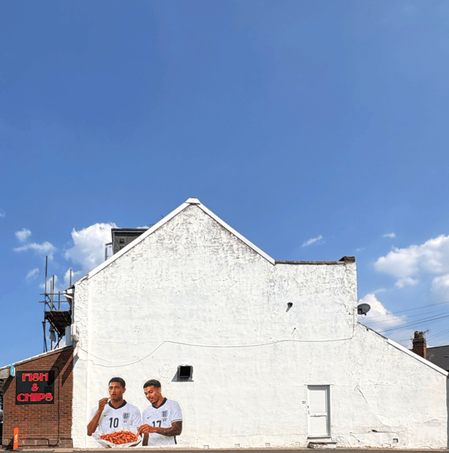 Mural of Jude Bellingham and Morgan Rogers eating orange chips appears in Quinton