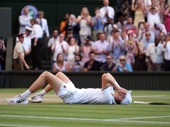 Jannik Sinner lies on the ground after his win