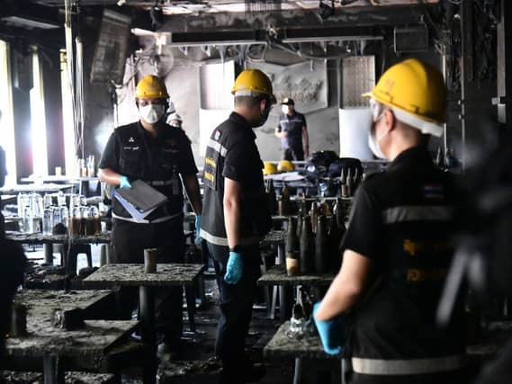 Officers inspect the site of the fire