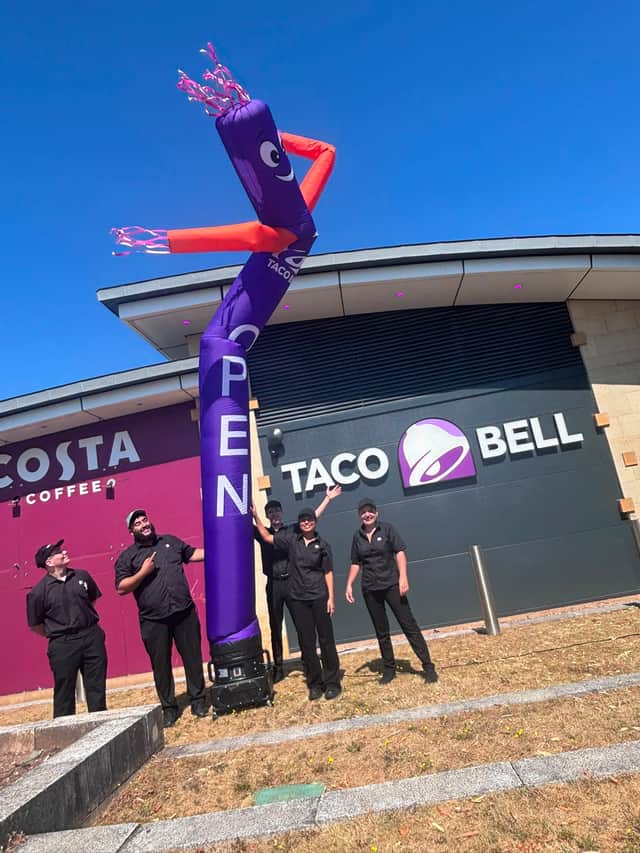 Staff outside the new Taco Bell restaurant at Merry Hill