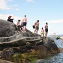 People jump into the water at the Forty Foot (Niall Carson/PA)