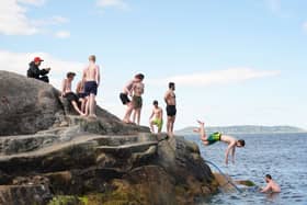 People jump into the water at the Forty Foot (Niall Carson/PA)