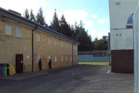Male detainees looking through the windows of the female unit at Dungavel immigration removal centre in South Lanarkshire