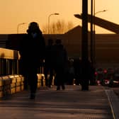 Commuters walk along Vauxhall Bridge, London
