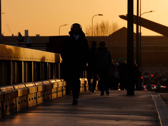 Commuters walk along Vauxhall Bridge, London