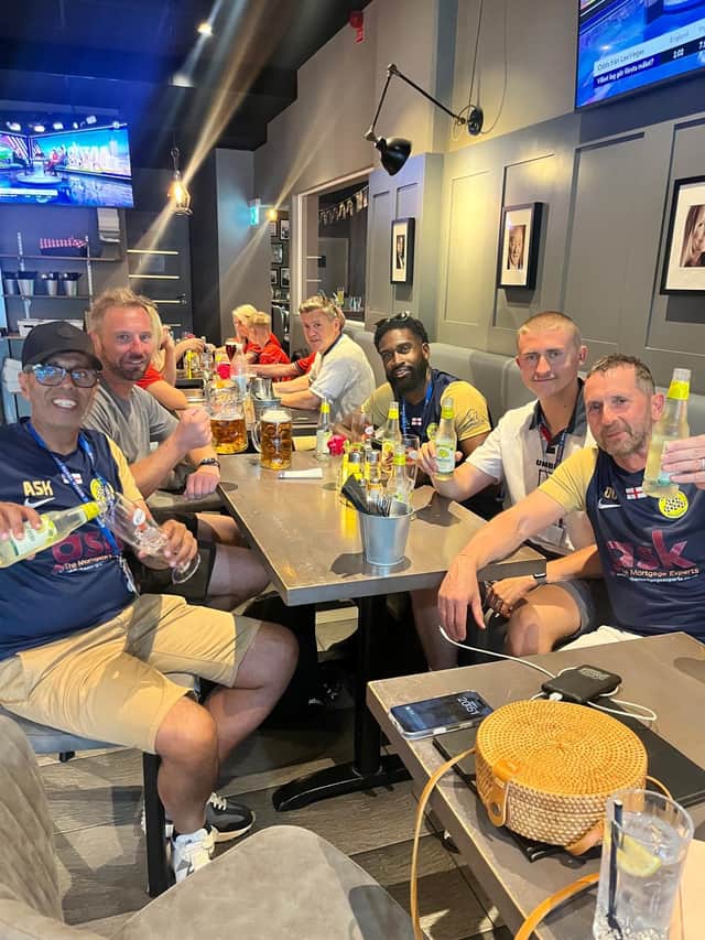 A well earned drink for the coaches, featuring one fool in an England kit