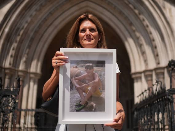 Ellen Roome holding a photo of her son Jools Sweeney outside the Royal Courts of Justice in London (Yui Mok/PA)