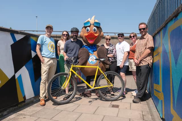 National Highways, Walk Wheel Cycle Trust and Sandwell Council funded various improvements to the subway. (From left-right Paul Meadows, Sandwell Council; Lauren Millward & Tom Conroy National Highways; Sandwell Council’s Auntie Duck; Sarah Redfern National Highways; artist Rob Fenton, artist’s wife Kirsty Fenton and Kierson Wise, Walk Wheel Cycle Trust). Photo: National Highways
