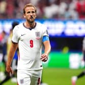 Harry Kane walking towards the camera during a football match