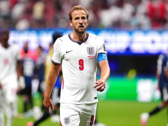 Harry Kane walking towards the camera during a football match