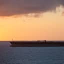 An oil tanker at sea at sunset